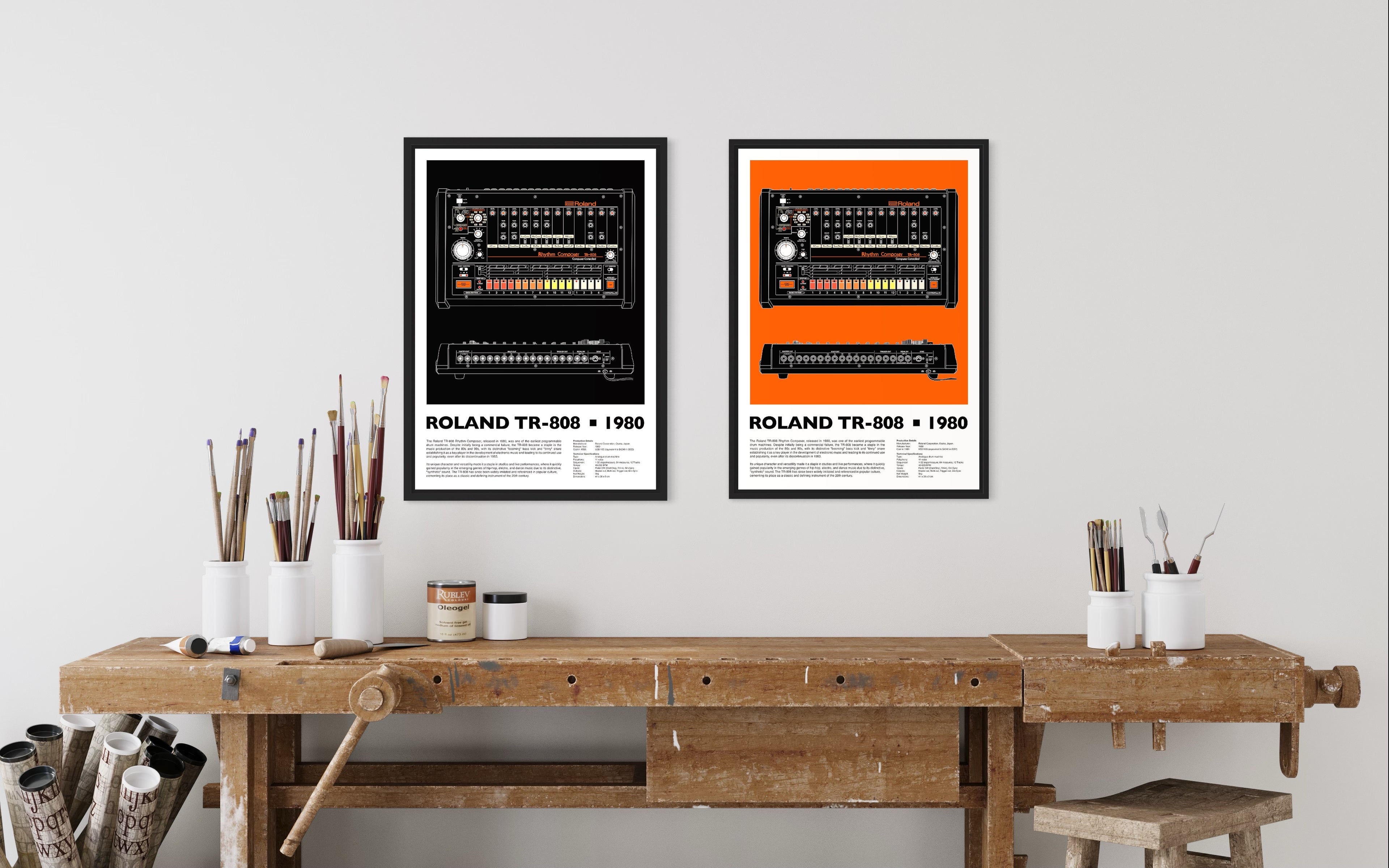 Two wall mounted TR-808 drum machine prints in black frames on an artists studio wall